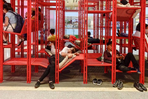 Red iron rack with seating and lounging area for customers to rest
