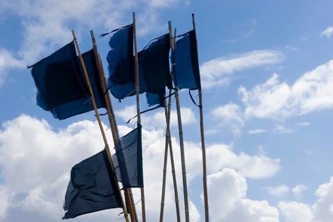 Flags and pennants to mark nets and fish traps laid out in the harbour of Hvide Sande
