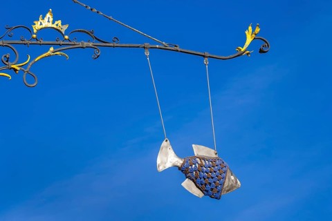 Guild sign with fish in the historic old town