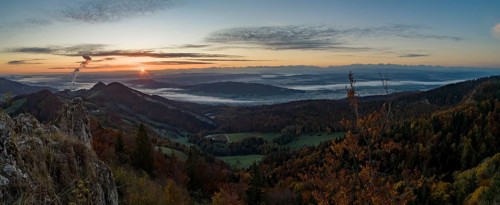 Sunrise with autumn fog with alpine panorama