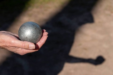 Man's hand holding petanque ball