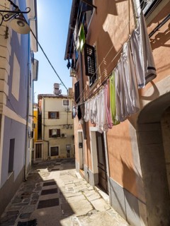 Laundry hanging to dry in a narrow alleyway of the old town of Izola