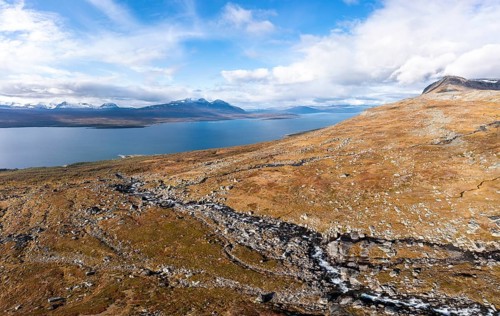 Autumnal fell landscape with a view of the lake Akkajaure and the mountain range Akka