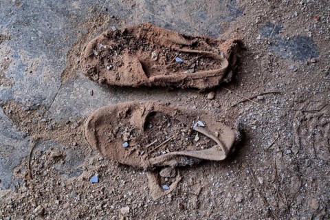 Pair of dilapidated canvas shoes from above