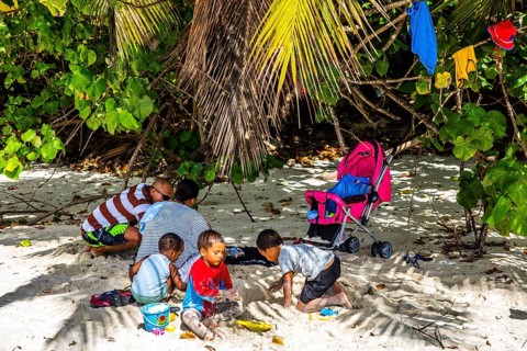 Family at the weekend on the beach Baie Lazare