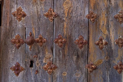 Old wooden door with fittings and keyhole