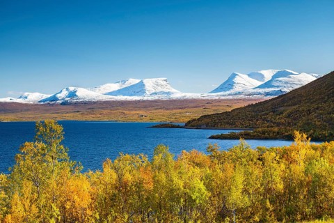 Snowy mountain group Lapporten and lake Tornetraesk