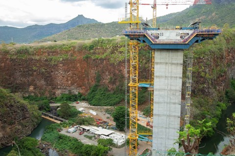 Construction site of bridge with crane across the Grand River of North West near the city of Beau Bassin
