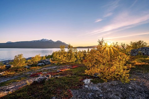 Autumnal fell landscape with lake Akkajaure and mountain range Akka