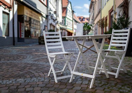 Wooden table and chair in a small alley