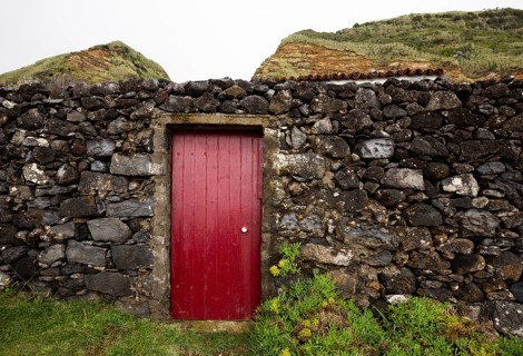 Lava stone garden wall with red front door