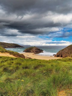 View of rocky coast with sandy beach