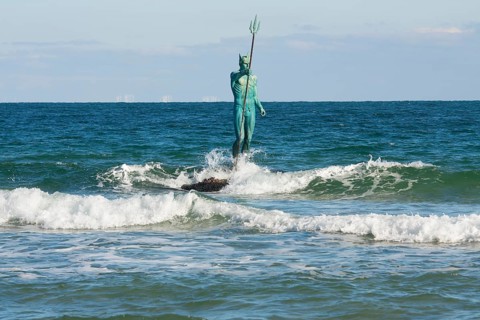 Sculpture of Neptune in sea near the beach