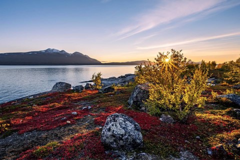 Autumnal fell landscape with lake Akkajaure and mountain range Akka