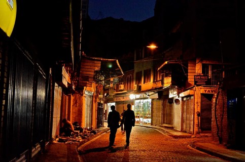 Two men on street in old town Eminoenue at night