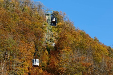 Cable car up the large castle hill in autumn