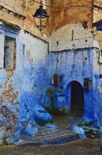 Blue house corner with archway in an alley