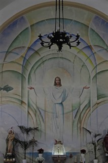 Mural of Jesus with outstretched arms in church