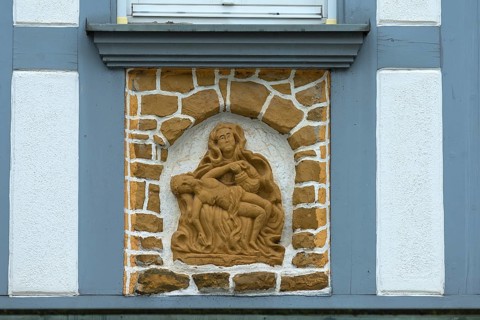 Religious relief on a historic half-timbered house from 1850