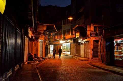 Two men on street in old town Eminoenue at night