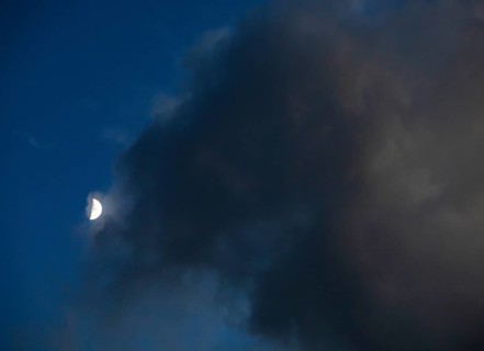 Evening sky with clouds and half moon