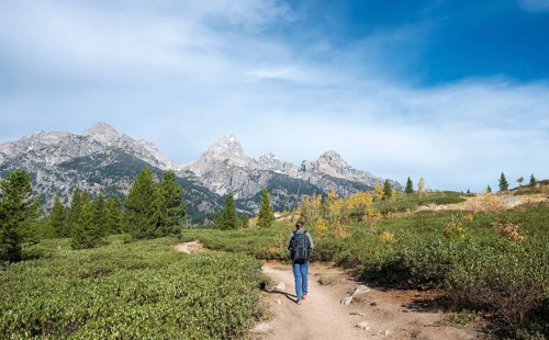 Young man on the hiking trail to Taggart Lake