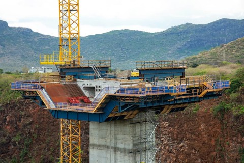 Construction site of bridge with crane across the Grand River of North West near the city of Beau Bassin