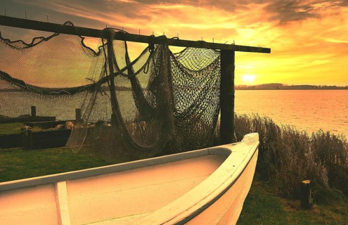 Fishing nets and fishing boat in the sunset