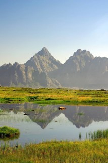 High mountains reflected in a small lake