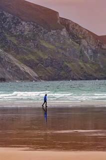 Walker walking along the beach in the evening