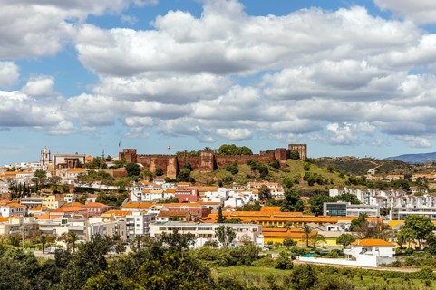 Silves cityscape with Moorish castle and cathedral on the top of the hill