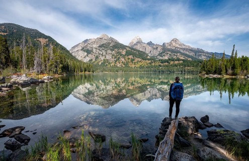 Young woman standing at a lake