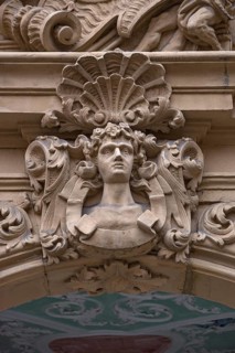 Man's head and shell in half relief above the entrance portal of the Baroque Boettinger House