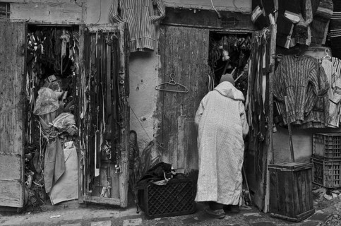 Man in jellaba in front of souvenir shop