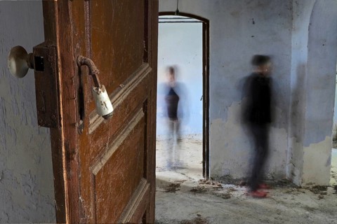 Open door with two people in abandoned house