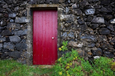 Lava stone house facade with red front door