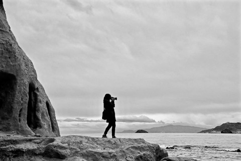 Woman taking photo at the sea