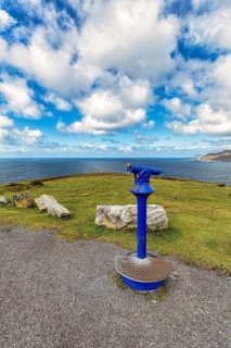 Viewpoint with blue telescope on the coast
