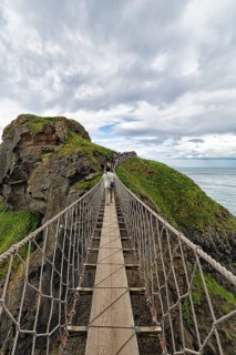 Narrow suspension bridge for pedestrians on rocky coast