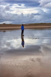 Man standing on the beach in the evening