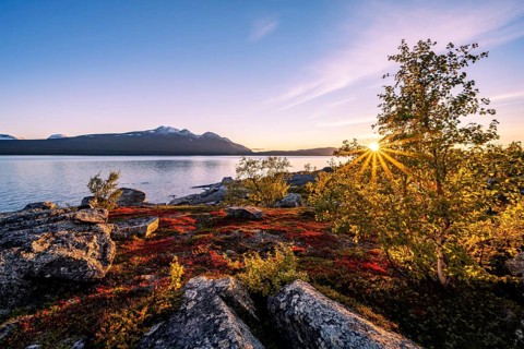 Autumnal fell landscape with lake Akkajaure and mountain range Akka