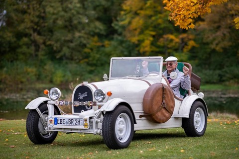 An elderly gentleman sitting in his replica of a 1923 Bugatti 35 B