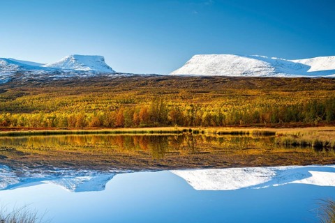 Mountain group Lapporten reflected in small pond
