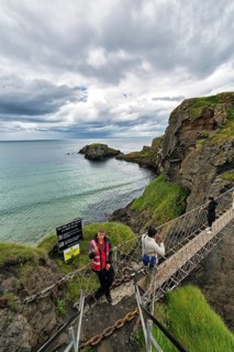 Narrow suspension bridge for pedestrians on rocky coast