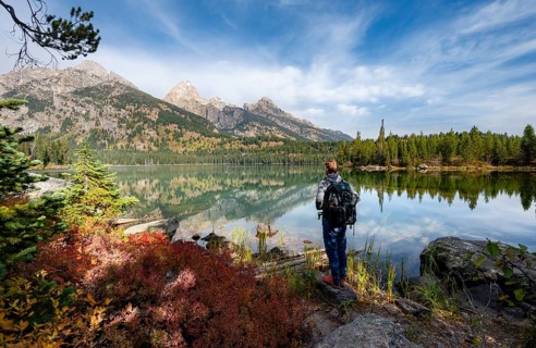 Young man standing by a lake