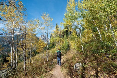 Young man on the hiking trail to Taggart Lake