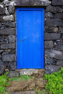 Lava stone house facade with blue front door