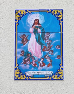 Typical Portuguese tile painting with saint motifs at the house entrances