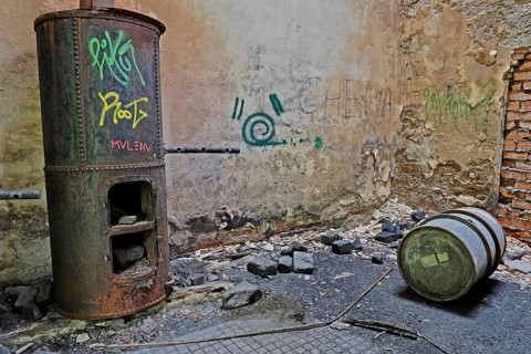 Coal stove and oil barrel in warehouse at Canfranc railway station