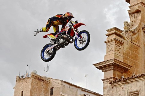 Flying motorbike artist above the rooftops of the old town